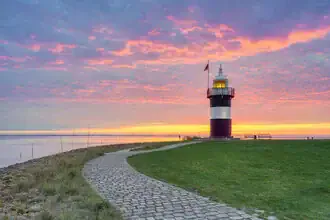 Photo art: Kleiner Preuße lighthouse in Wremen against a calm sunset