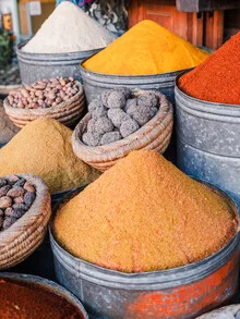 Colorful spices at a Moroccan market, warm light and inviting atmosphere.
