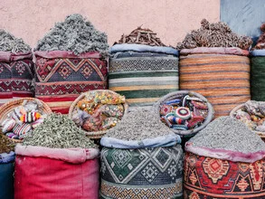 Colorful spices at a market in Marrakesh, warm lighting and an inviting atmosphere.