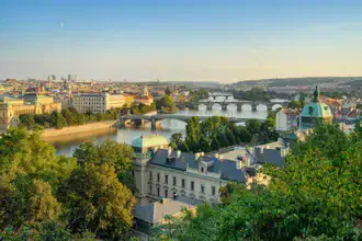 View over Prague: colorful sunset over the city featuring Prague Castle