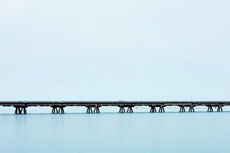 Photo art by Manuela Deigert: bridge over calm waters and expansive sky