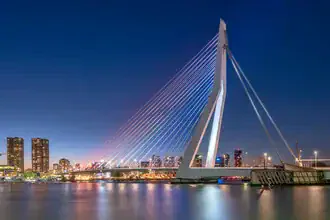 Photo art by Achim Thomae: illuminated Erasmus Bridge in Rotterdam at blue hour.