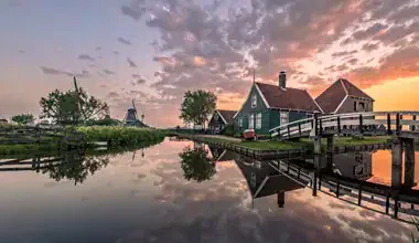 Photo art by Achim Thomae: Sunrise over a Dutch village with windmills.