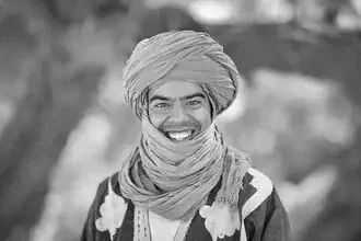 Portrait of an Amazir wearing a turban in the desert, capturing the essence of the Sahara.