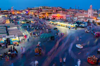 Market in Marrakech, vibrant scene with colorful stalls and cheerful people.