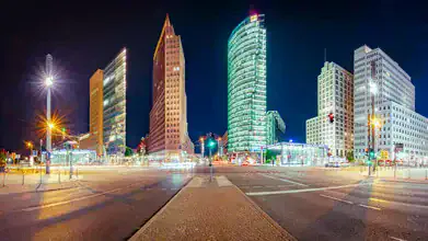 Night photo of Potsdamer Platz: illuminated buildings and calm atmosphere