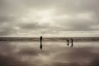 Minimalist silhouette of a family on a beach in Denmark, calm mood.
