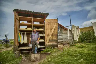 Landscape photo of a cheesemaker in the Eastern Carpathians