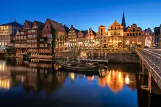Photo art by Achim Thomae: historic architecture by the illuminated old harbour in Lüneburg.