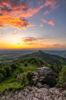Sunset over Hohenzollern Castle with warm colors and a serene atmosphere.