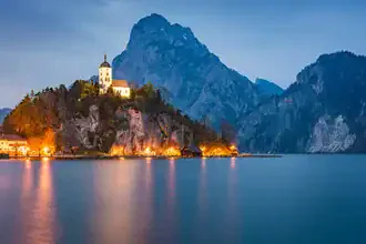 Photo art by Martin Wasilewski: calm blue hour at Lake Traunsee with mountains in the background