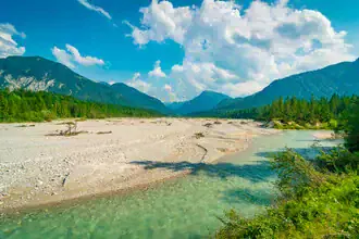 Photo art by Martin Wasilewski: Summer landscape by the river with mountains in the background.