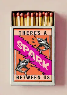 Wall art featuring a humorous quote about sharks and lighting matches.