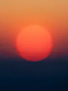 Calm photo art featuring soft colors of a sunset over the landscape.