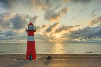 Photo art of a lighthouse in Westkapelle at sunset, soft colors in the sky.