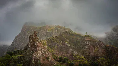 Photo art by J. Daniel Hunger: soft fog surrounds tall mountains
