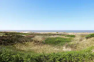 Photo art by Manuela Deigert: calm dune landscape with wide sea view