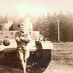 PFC Harvey Finch poses for this photo in front of a M2A2 Tank at Ft. Lewis, Washington. Finch&Tank1