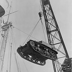 Tank of the 194th Tank Battalion suspended in the air as it is unloaded at Manila.