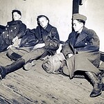Members of D Company take a nap as they await their train in November 1941. Harrodsburg Tankers637