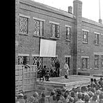 The POWs are shown receiving the news that Japan had surrendered Mukden Surrender Announcement