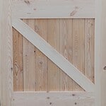 This image showcases a robust Baltic barn door, ideal for farm use. Crafted from durable Baltic wood, this door combines rustic charm with practical functionality, making it perfect for any agricultural setting. Baltic Barn Door