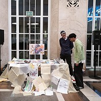 Engaging conversation at a lively art exhibition surrounded by diverse creative works.