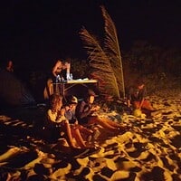 Enjoying a beach bonfire with friends under the stars in the Philippines. Beach bonfire with friends at night in the Philippines.