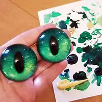 Acrylics Rounded slit pupil eyes with iridescent green/gold irises.