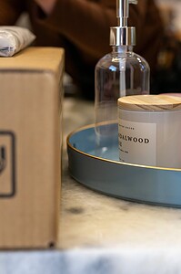 Decorative pink and clear glass accessories with wooden lid and tray.