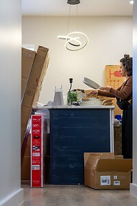 Professional woman organizing kitchen.