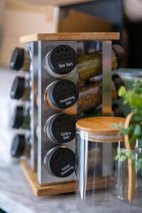 A spice rack featuring sea salt, seasoning salt, celery salt, and Italian seasoning for cooking and kitchen organization.