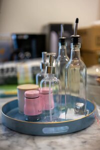 Stylish soap dispensers and glass bottles for kitchen or bathroom organization.