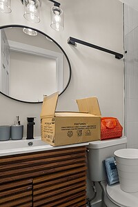 Contemporary bathroom featuring walk-in shower, stylish vanity, and geometric wall tiles for elegance.