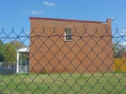 The now empty lot was once occupied by six attached row houses facing the left field wall, each with a small, enclosed backyard