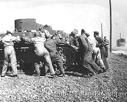Members of B Co. push a tank. Tank Pushing