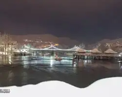 Krušnica rijeka u zimskom okruženju s mostom i snježnim obalama, noćni pejzaž u Bosni i Hercegovini. Krušnica rijeka u zimskom okruženju s mostom i snježnim obalama.