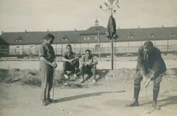 Capt Alexander right playing golf Bischofswerda POW camp, Hannover, Germany. Undated.