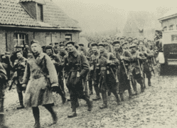 Pipe Band marching from billets in Kortepyp, Belgium and entering Bailleul, France, the early afternoon of March 25th, 1916