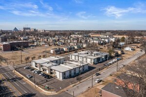 Aerial view of contemporary residential apartments and surrounding community.