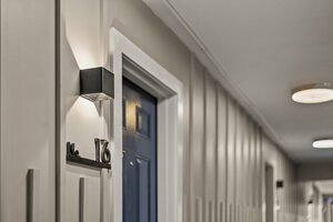 Modern hallway with black wall light, house number 16, sleek design, contemporary interior decor.