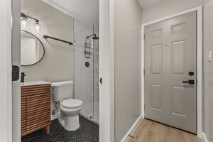 Stylish bathroom with walk-in shower, white fixtures, and modern design elements.