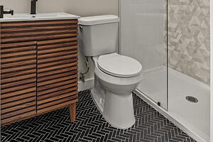 Bathroom interior featuring modern decor, black fixtures, and a glass-enclosed shower.