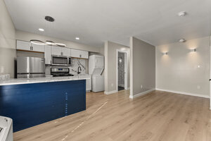 Bright open living space with wood flooring and subtle lighting.