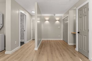 Bright, minimalist living space with neutral colors and sleek lighting fixtures.