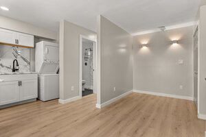 Laundry room with washer and dryer, small bathroom with toilet and shower.