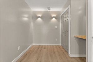 Bright, minimalistic space with built-in closet and subtle lighting accents.