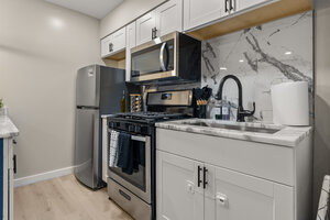 Optimal keywords: modern kitchen, stainless steel appliances, marble backsplash, home kitchen design.
