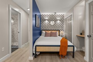 Contemporary bedroom featuring a bold accent wall, plush bedding, and inviting cozy ambiance.