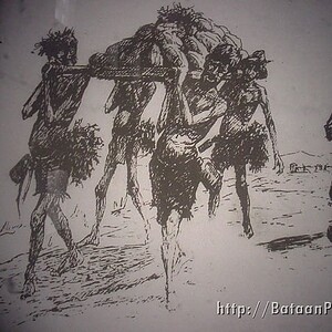 POWs carry a load of rocks while building runways on a work detail.
Courtesy of Ben Steele © POWs carry a load of rocks